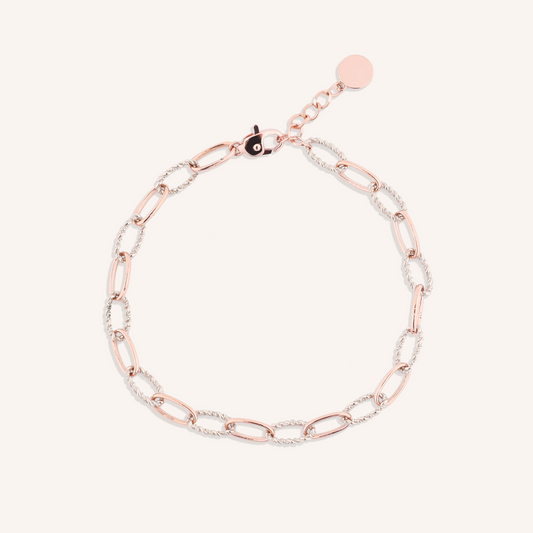 Two-tone rose gold and silver chain bracelet on a white background