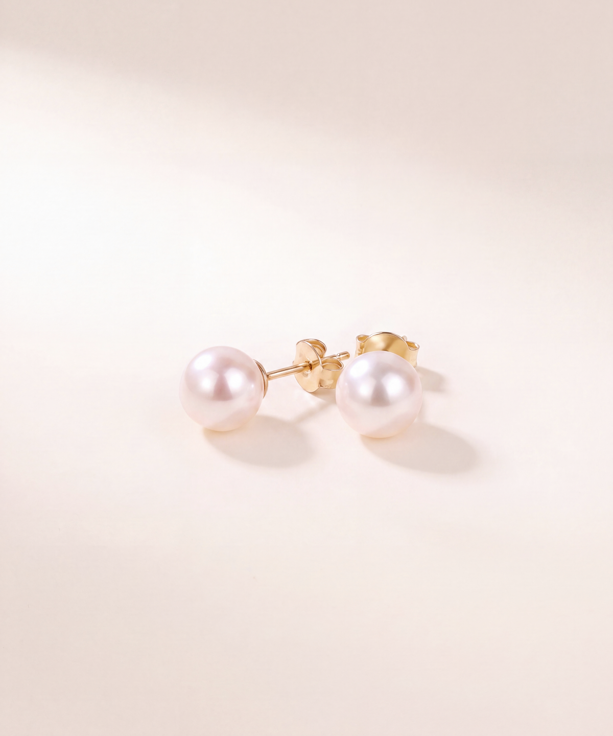 Akoya pearl stud earrings, pair with butterfly backs, studio shot