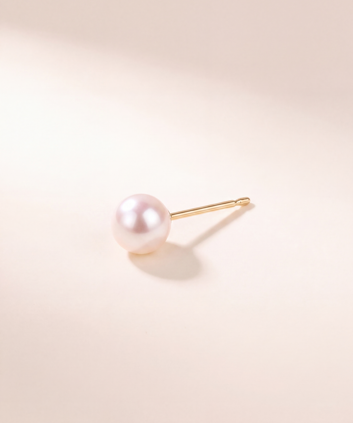 Akoya pearl stud earring, side view showing the post, studio shot