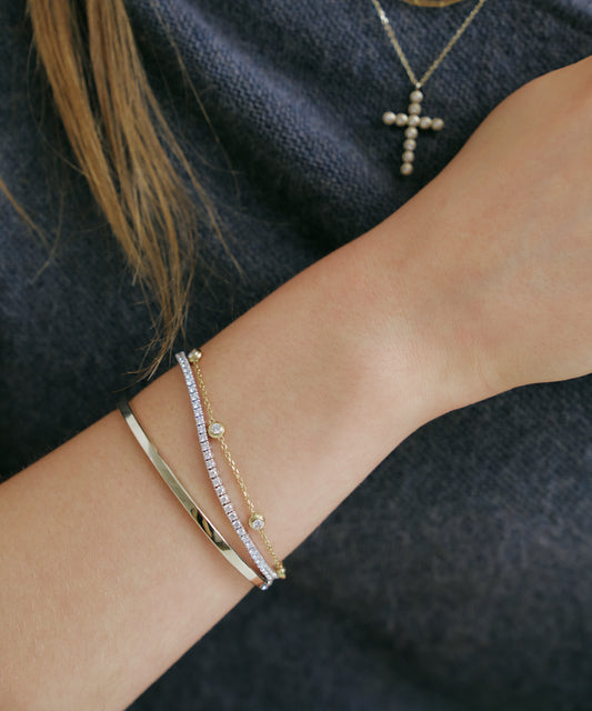 Yellow Gold | Lab Grown Diamond Bezel Station Bracelet, 5 Stones, worn, stacked with tennis bracelet and bangle