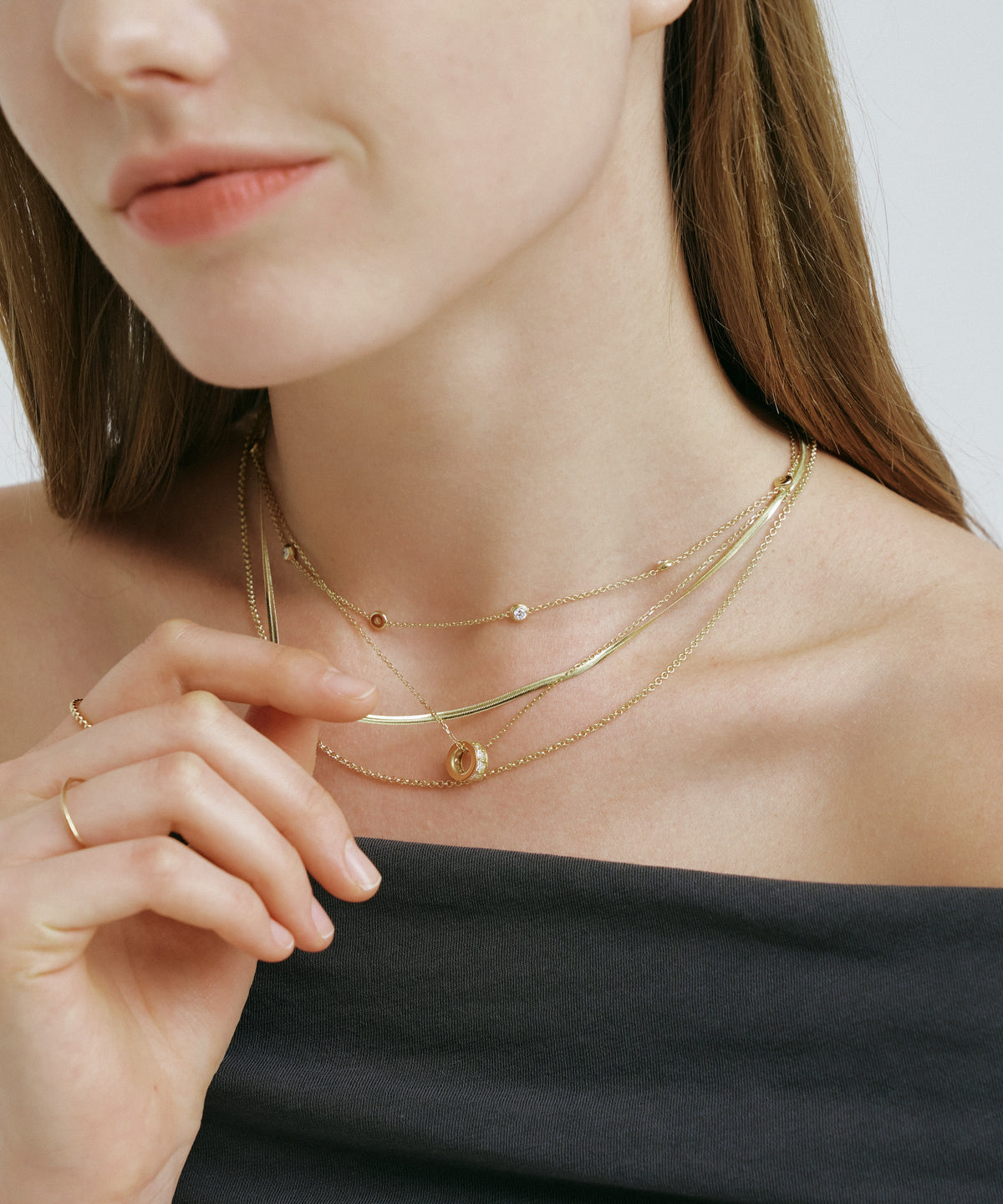 Yellow Gold | Lab Grown Diamond Bezel Station Necklace, 8 Stones, worn, hand at the neckline