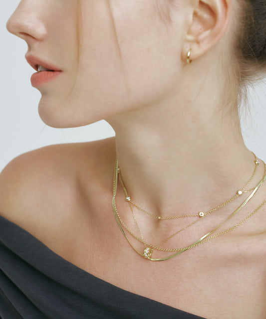 Yellow Gold | Lab Grown Diamond Bezel Station Necklace, 8 Stones, worn, three-quarter view, layered with snake chain