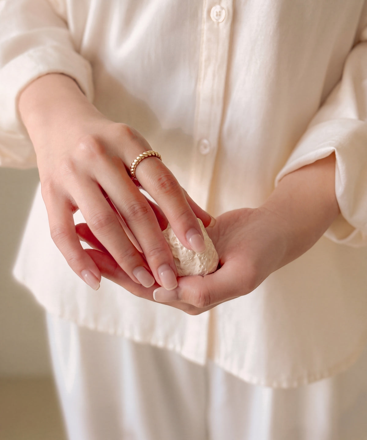 Brioche Ring on a hand holding a stone