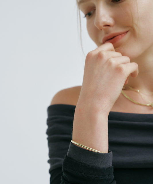Yellow Gold | Classic Bangle, worn, smiling, hand at the lips