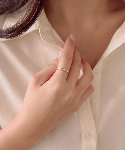 Milgrain marquise eternity band worn on the index finger, hand resting at a shirt collar