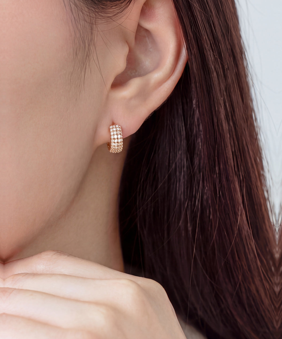 Pavé Lab Grown Diamond Ribbed Huggie Hoop Earrings in Rose Gold worn, hand at the jaw