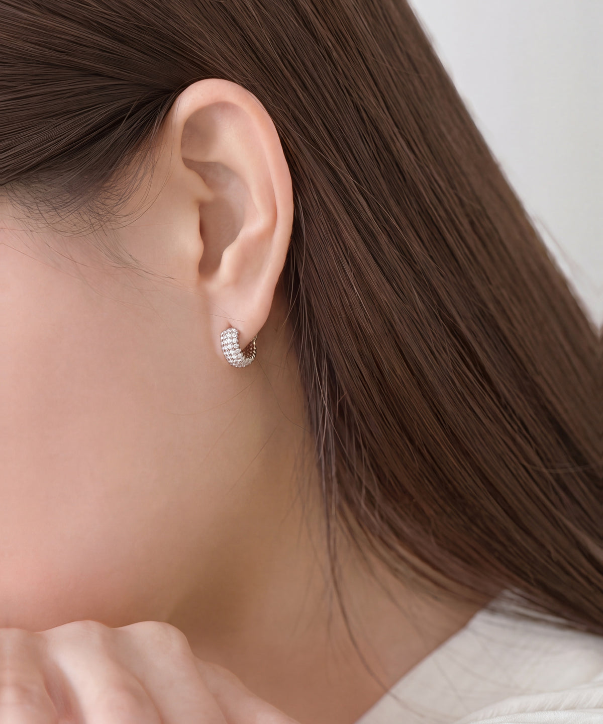 Pavé Lab Grown Diamond Ribbed Huggie Hoop Earrings in White Gold worn, profile with hair back