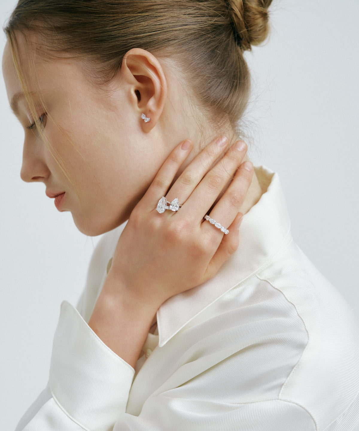 White Gold | Tangent Stud Earrings, worn, hand at the neck