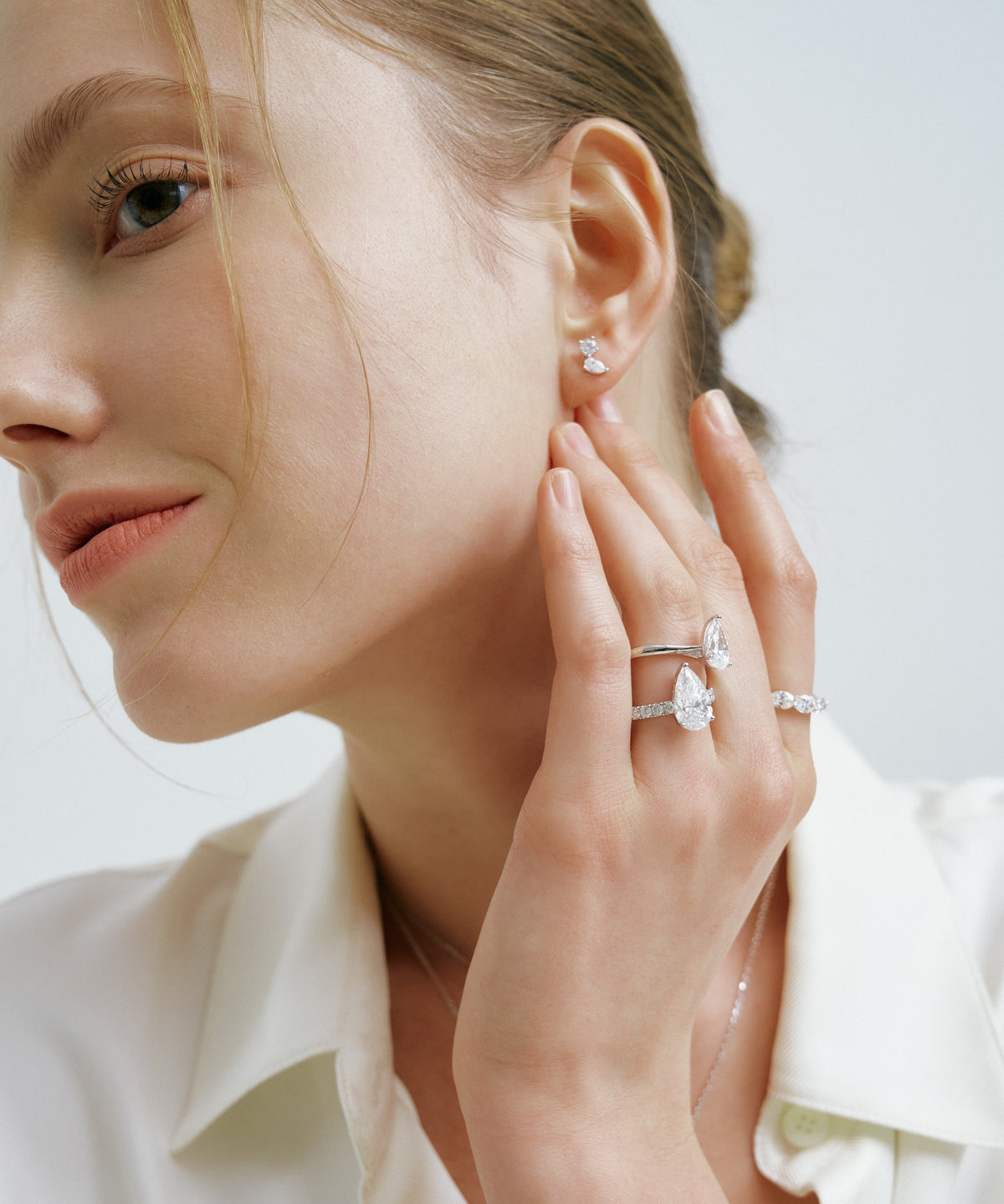 White Gold | Tangent Stud Earrings, worn, hand at the ear